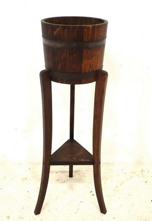 A Lister oak jardiniere, bound with copper, tripod stand, 25 by 91cm high.