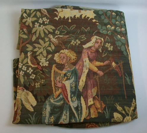 A 20th century French wall tapestry depicting attendants amidst the foliage and flora within the