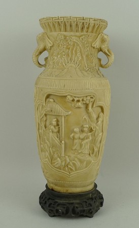 A Chinese resin vase of shouldered, ovoid form with twin elephant's head handles, decorated in