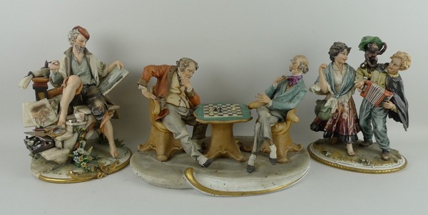 A Capo di Monte porcelain figure group by Tyche modelled as chess players, an accordion player