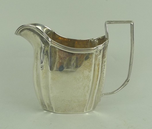 A George III silver cream jug with a fluted rim and handle, maker IB, London 1807, 3.64toz.