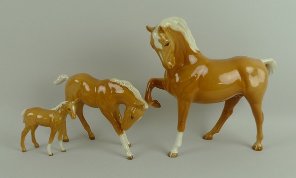A Beswick figure of a palomino horse, no 1549 1st version, and two palomino foals, nos 1813 and 947.