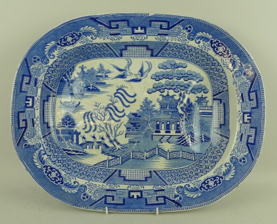 A pottery tree and well meat platter, early 19th century, transfer decorated in blue and white in