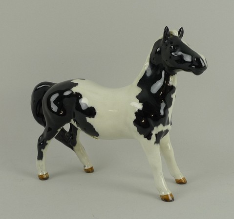 A Beswick model of a pie-bald 'Girls Pony', model number 1483, 13 by 13cm.