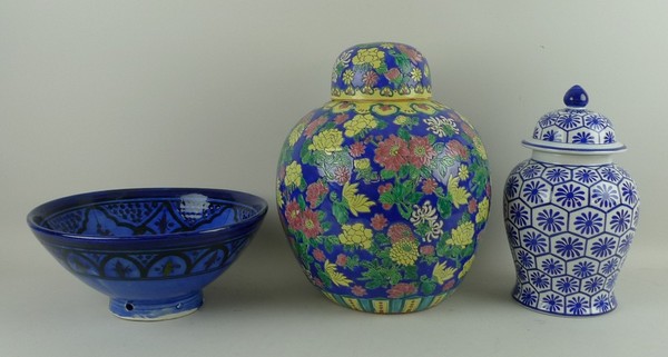 A Chinese porcelain jar and cover polychrome decorated with peonies and chrysanthemums against a