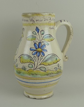 A German tin glazed earthenware German beer mug, late 18th century of baluster form, painted with