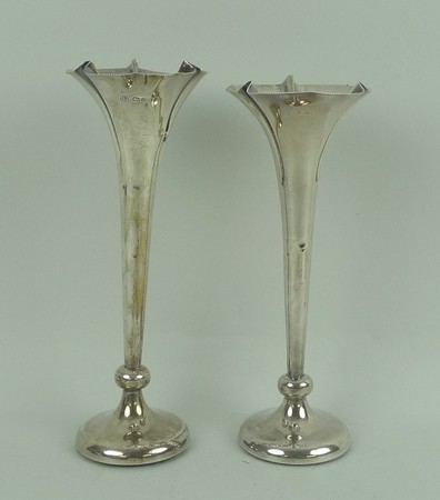 A pair of silver loaded vases of trumpet form, Chester 1909-1910, 9.60toz total weight, 20cm high.