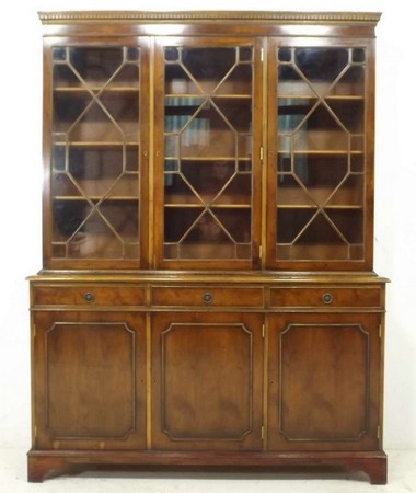 A Georgian style reproduction mahogany veneered bookcase, the upper section composed of four