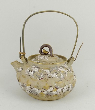 A Japanese studio ware teapot decorated with one hundred cranes, ruyi handle, 13 by 10cm.