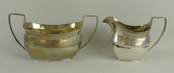 A George III silver cream jug and sugar bowl, London shape with an engraved vermicelli band above