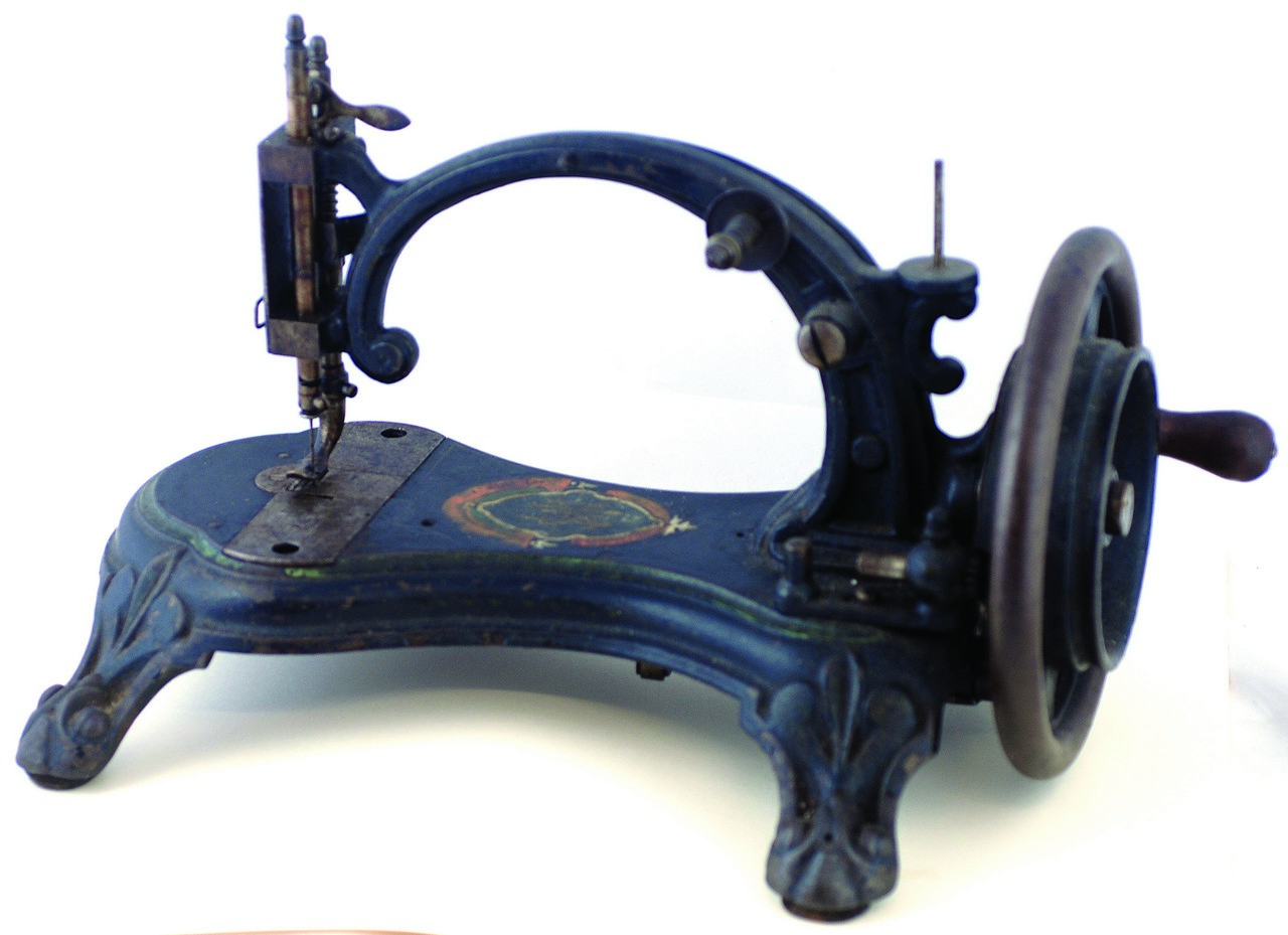 CAST IRON SEWING MACHINE ?THE LITTLE HOWE?. 10ins tall, paw foot design, hand stencilled t.m. Hand