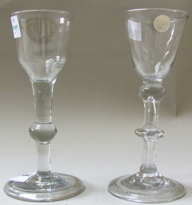 Two wine glasses, mid 18th century, the first with rounded funnel bowl above a double knopped stem