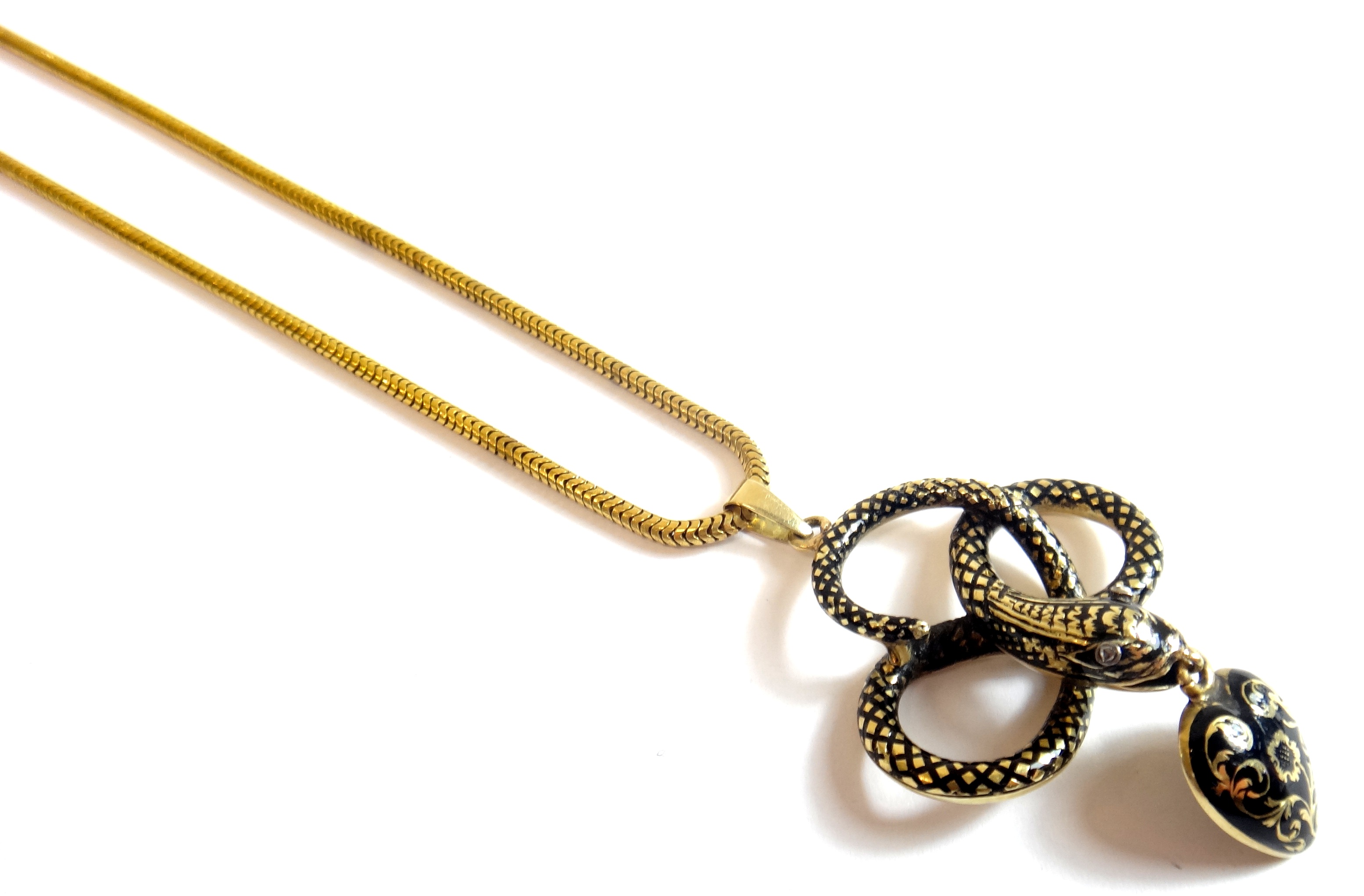 A Victorian gold and black enameled mourning pendant, designed as a coiled serpent, with rose