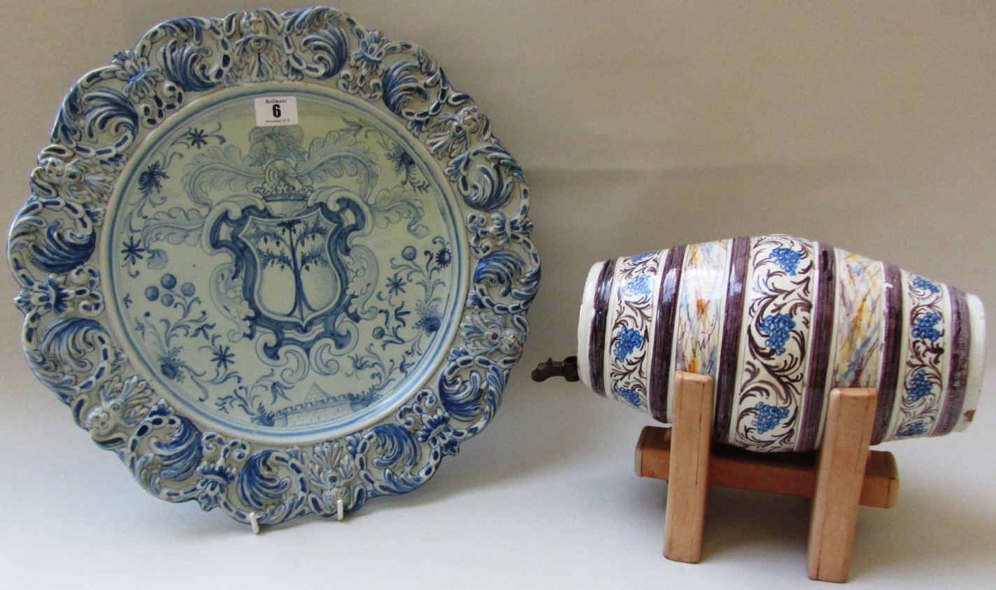 A Pavia armorial charger and an Italian maiolica spirit barrel, circa 1720, the second possibly