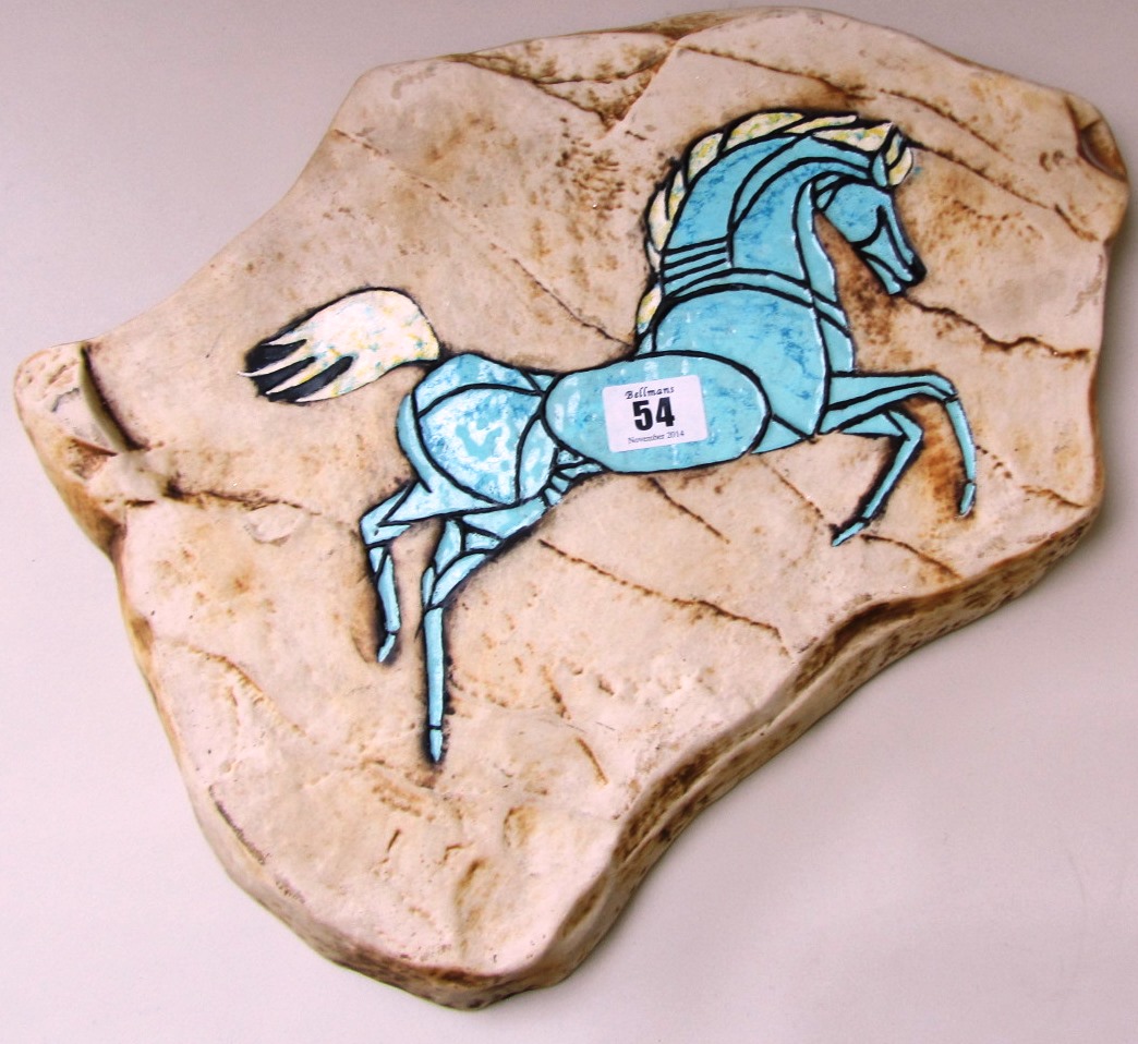 A Wade porcelain plaque modelled as a stone tablet, decorated with a turquoise prancing horse,