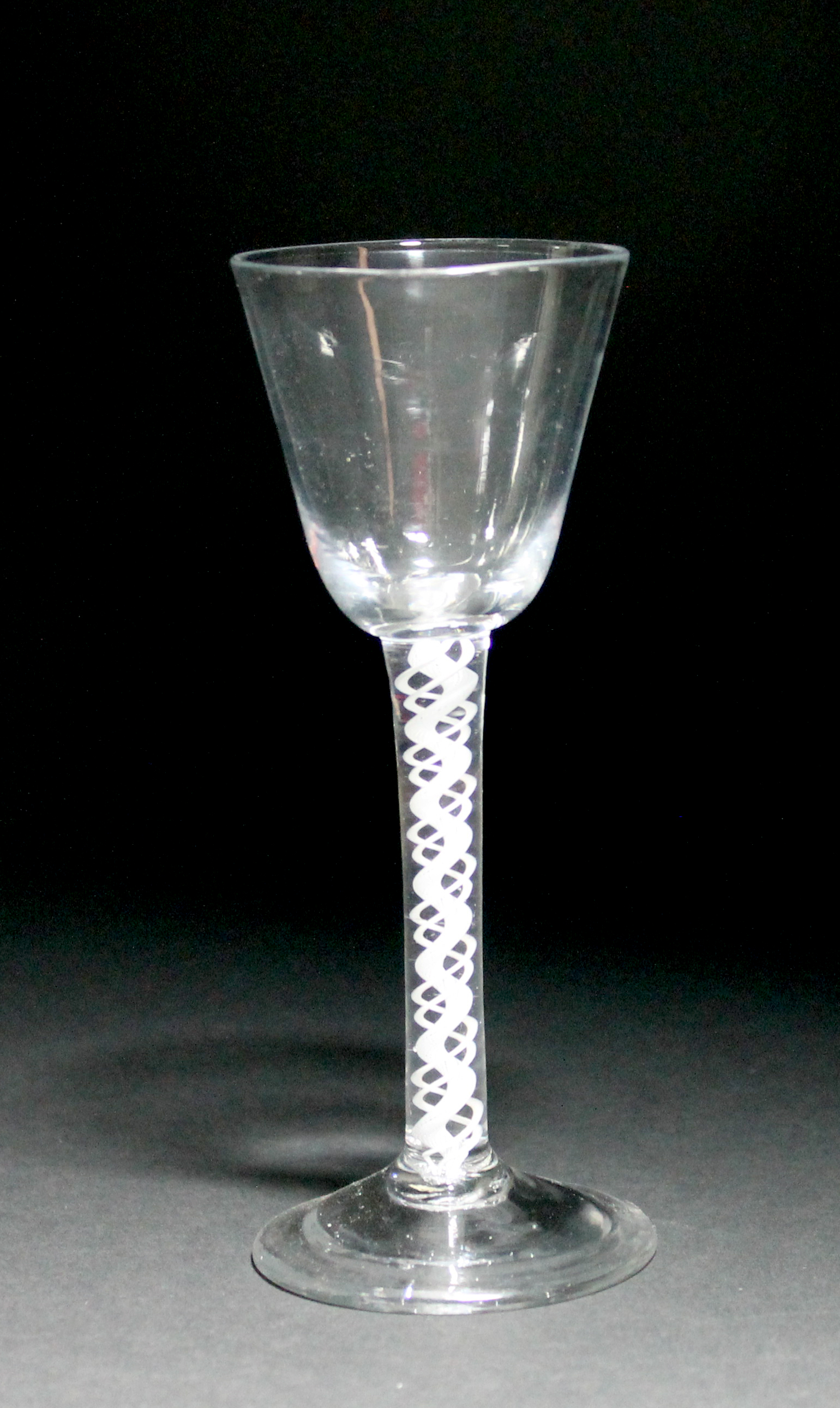 An opaque twist wine glass, circa 1765, the rounded funnel bowl raised on a double series opaque