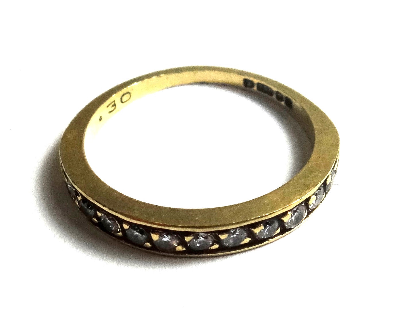 An 18ct gold and diamond set half hoop eternity ring, mounted with a row of circular cut diamonds,