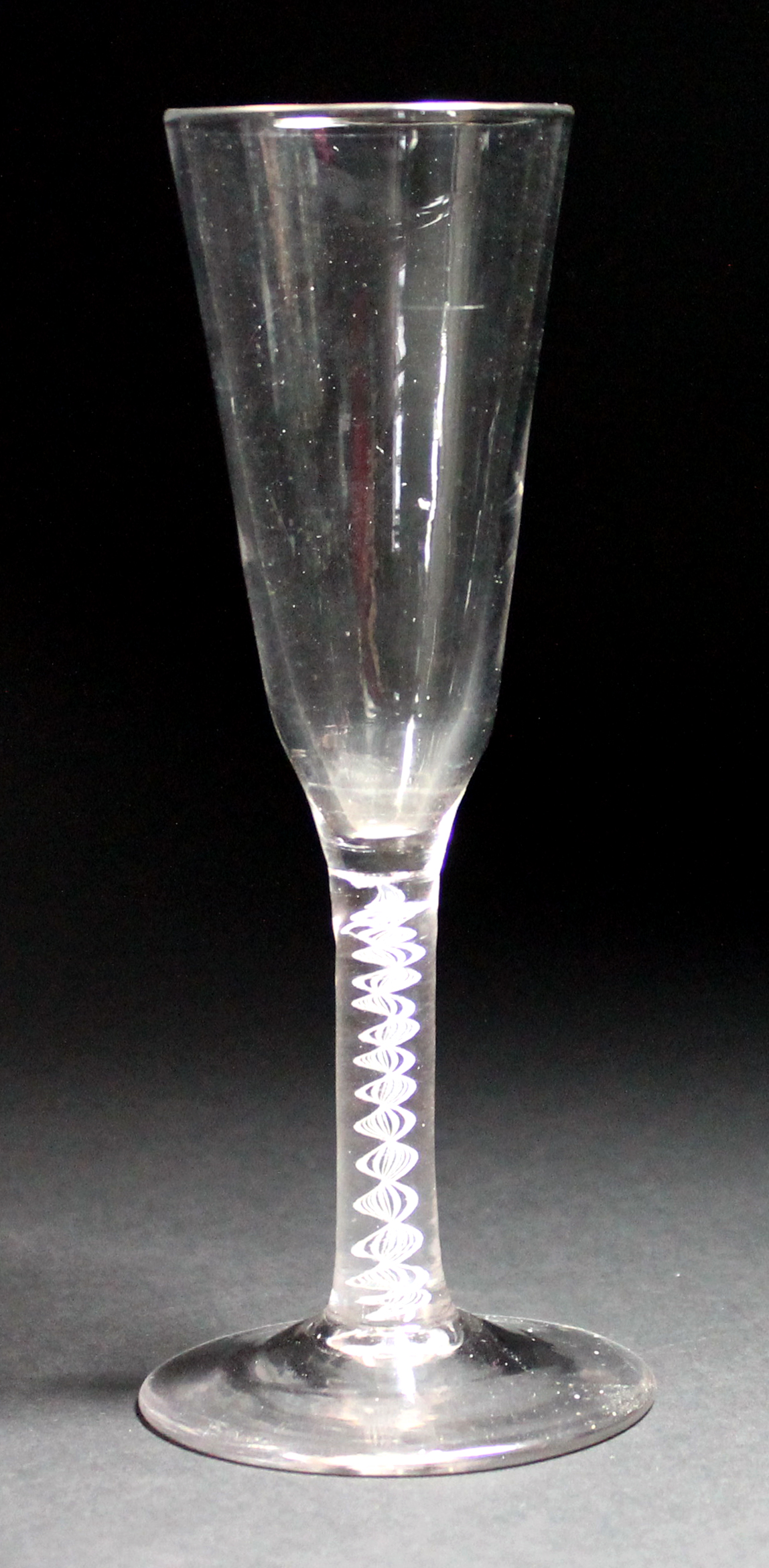 An opaque twist ale glass, circa 1765, the rounded funnel bowl raised on a single series opaque