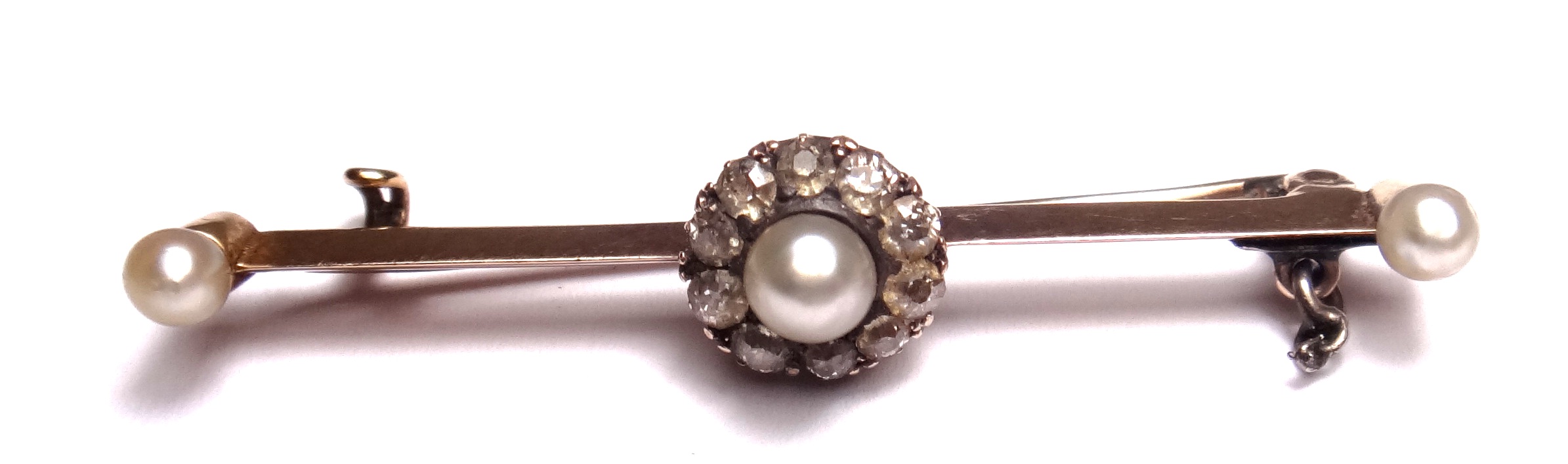 A diamond and cultured pearl set cluster bar brooch, the centre mounted with a cultured pearl within