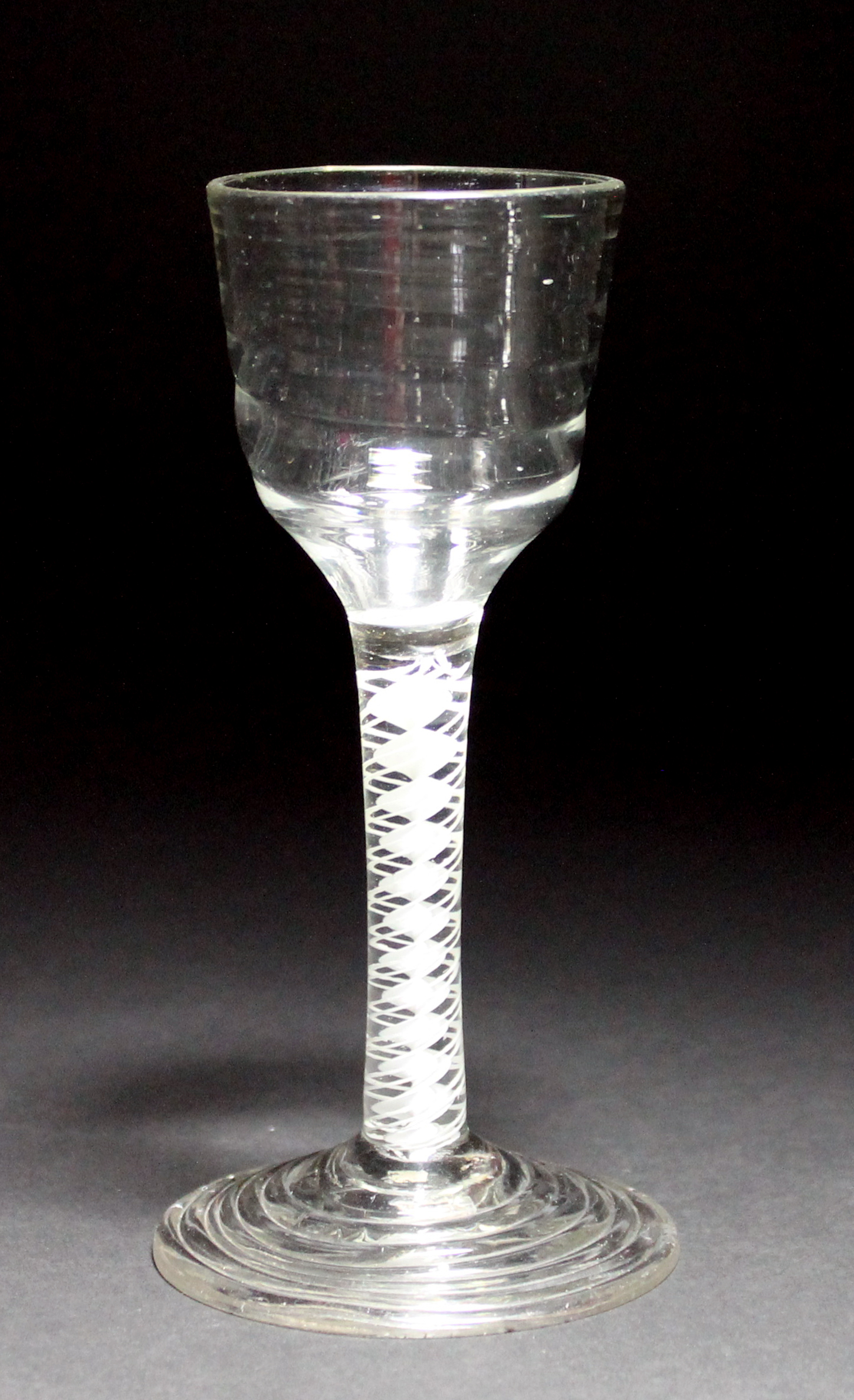 A `Lynn' wine glass, circa 1765, the ribbed ogee bowl raised on a double series opaque twist stem