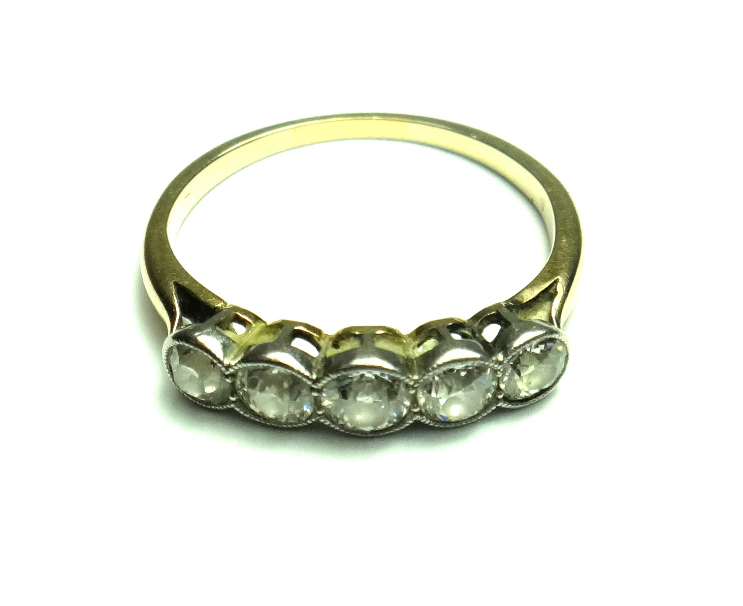 A gold and diamond set five stone ring, mounted with a row of collet set cushion shaped diamonds,