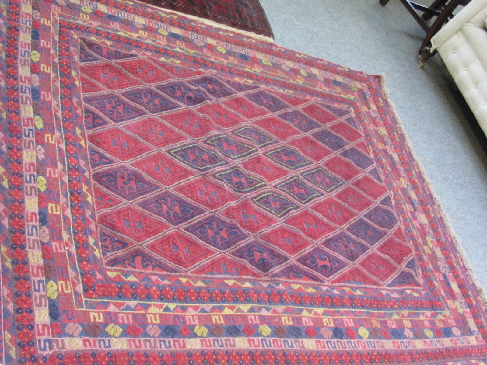 A Mashwani rug, an indigo and madder diamond field, various borders, 200cm x 160cm.