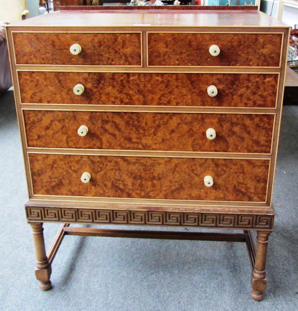 A 20th century amboyna and mahogany chest of two short and three long graduated drawers, on turned