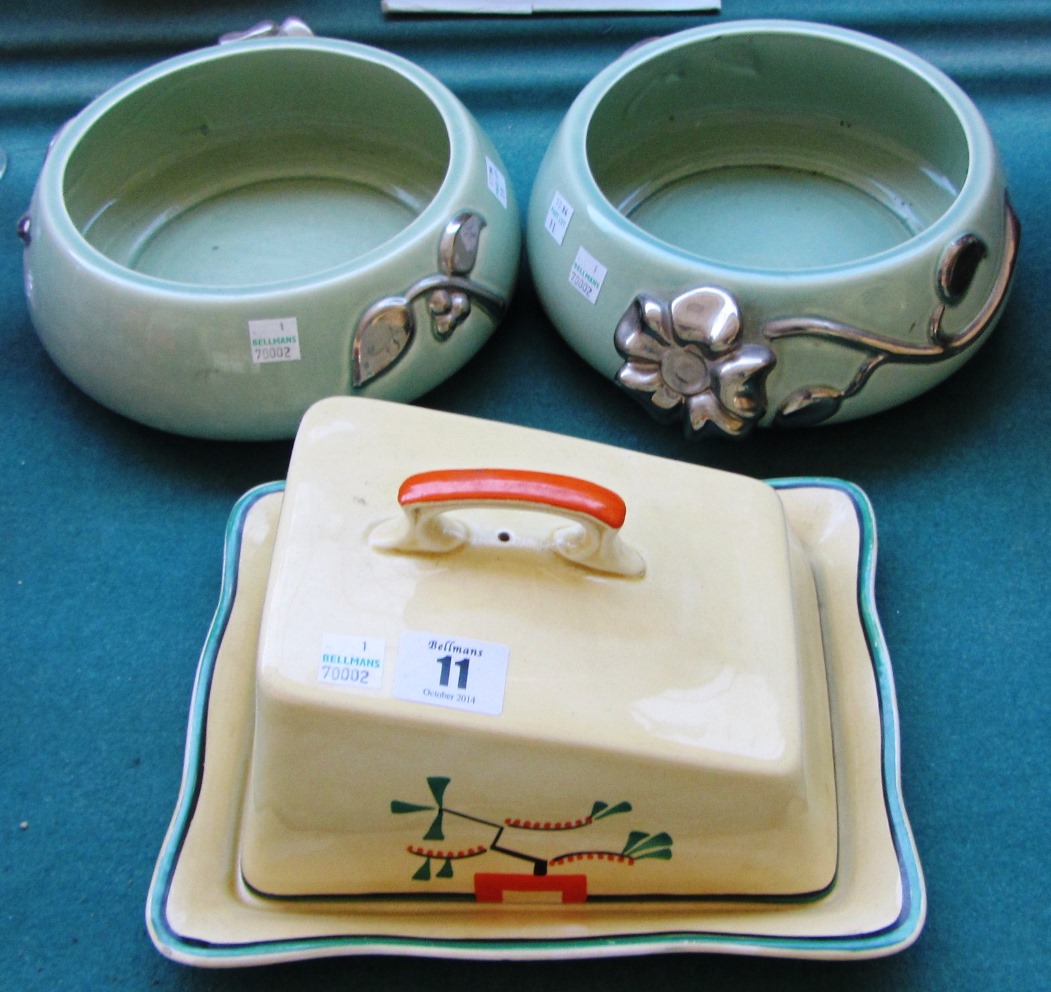 A Clarice Cliff pottery cheese dish and cover, decorated with geometric flora against a cream ground