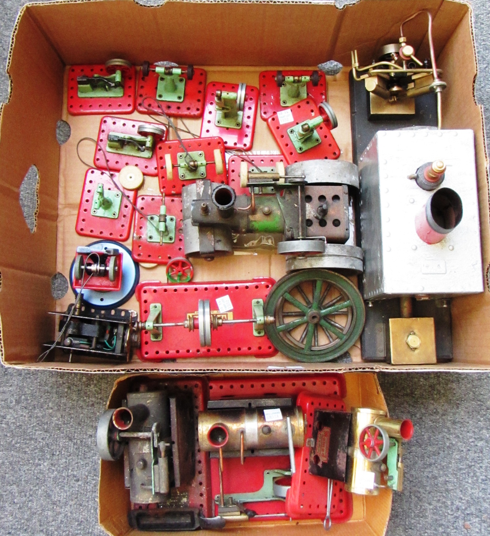 A group of mostly Mamod engines; three stationary engines, one rolling engine, one boat engine and
