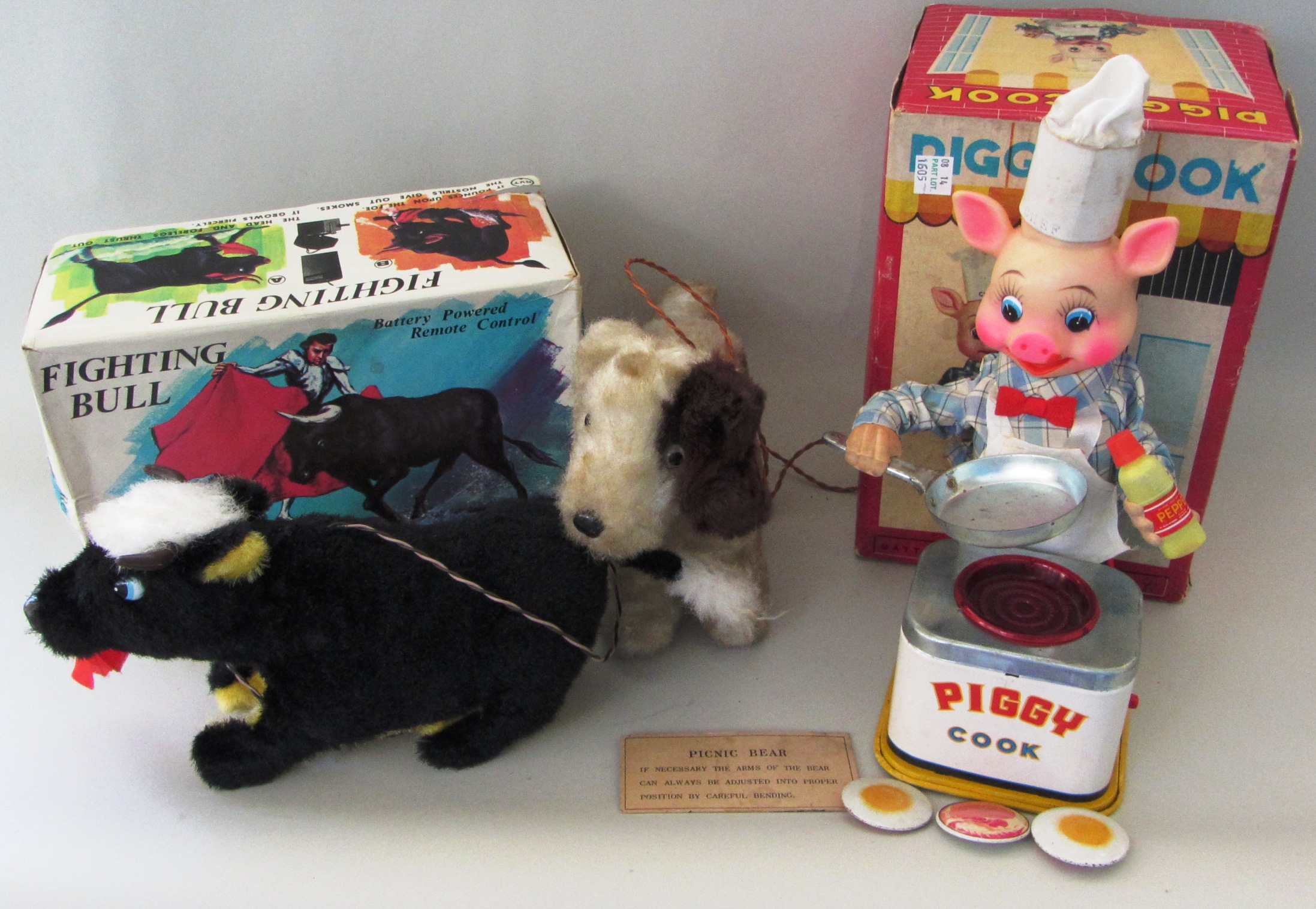 A Japanese remote control 'Fighting Bull', boxed, a Japanese talking dog, a Japanese 'Piggy Cook',