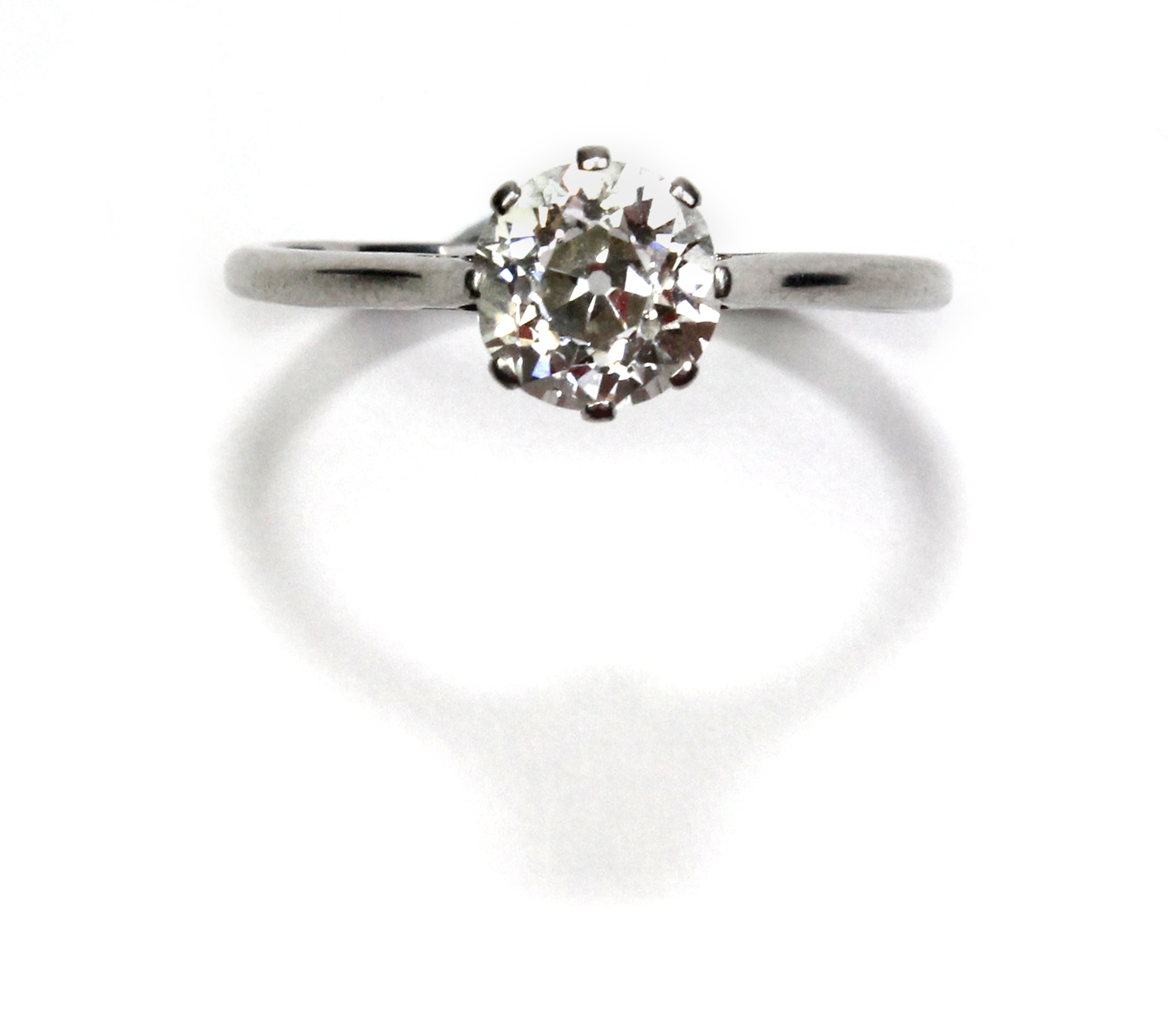 A platinum and diamond set single stone ring, claw set with a cushion shaped diamond, estimated