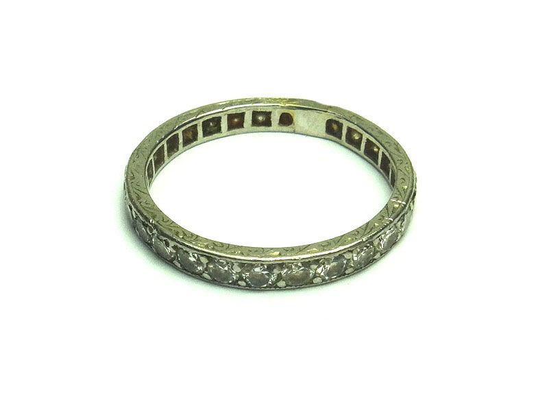 A diamond set full eternity ring, mounted with circular cut diamonds, slightly mis-shapen, ring size