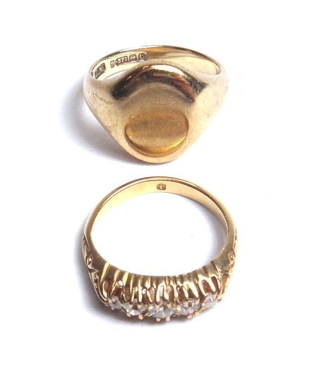 A gold and diamond set five stone ring, mounted with a row of cushion shaped diamonds, graduating in