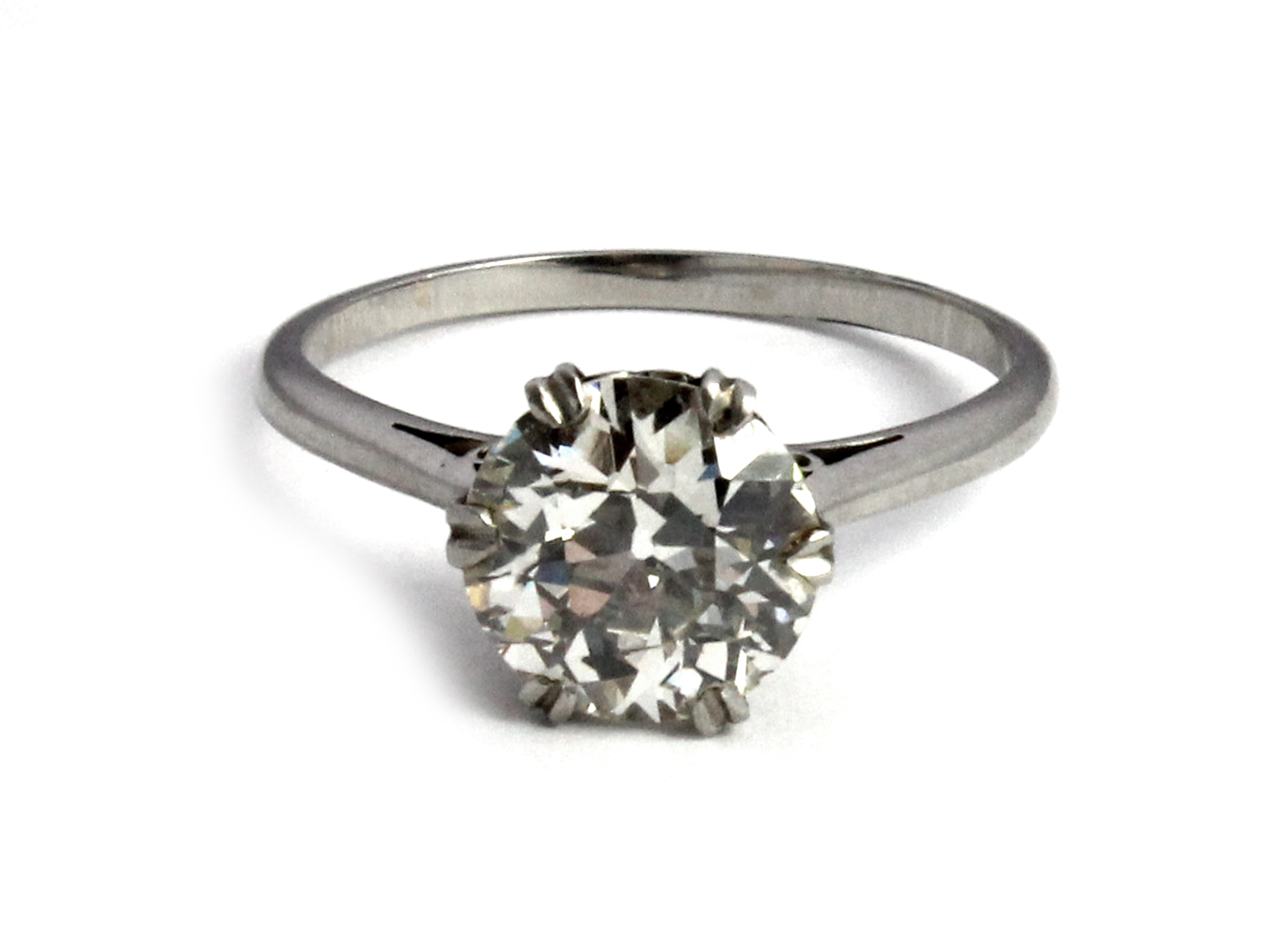 A diamond set single stone ring, claw set with an old cut cushion shaped diamond, estimated weight