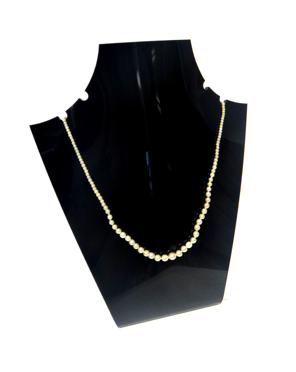 A single row necklace of graduated seed and cultured pearls, on a gold snap clasp, mounted with a