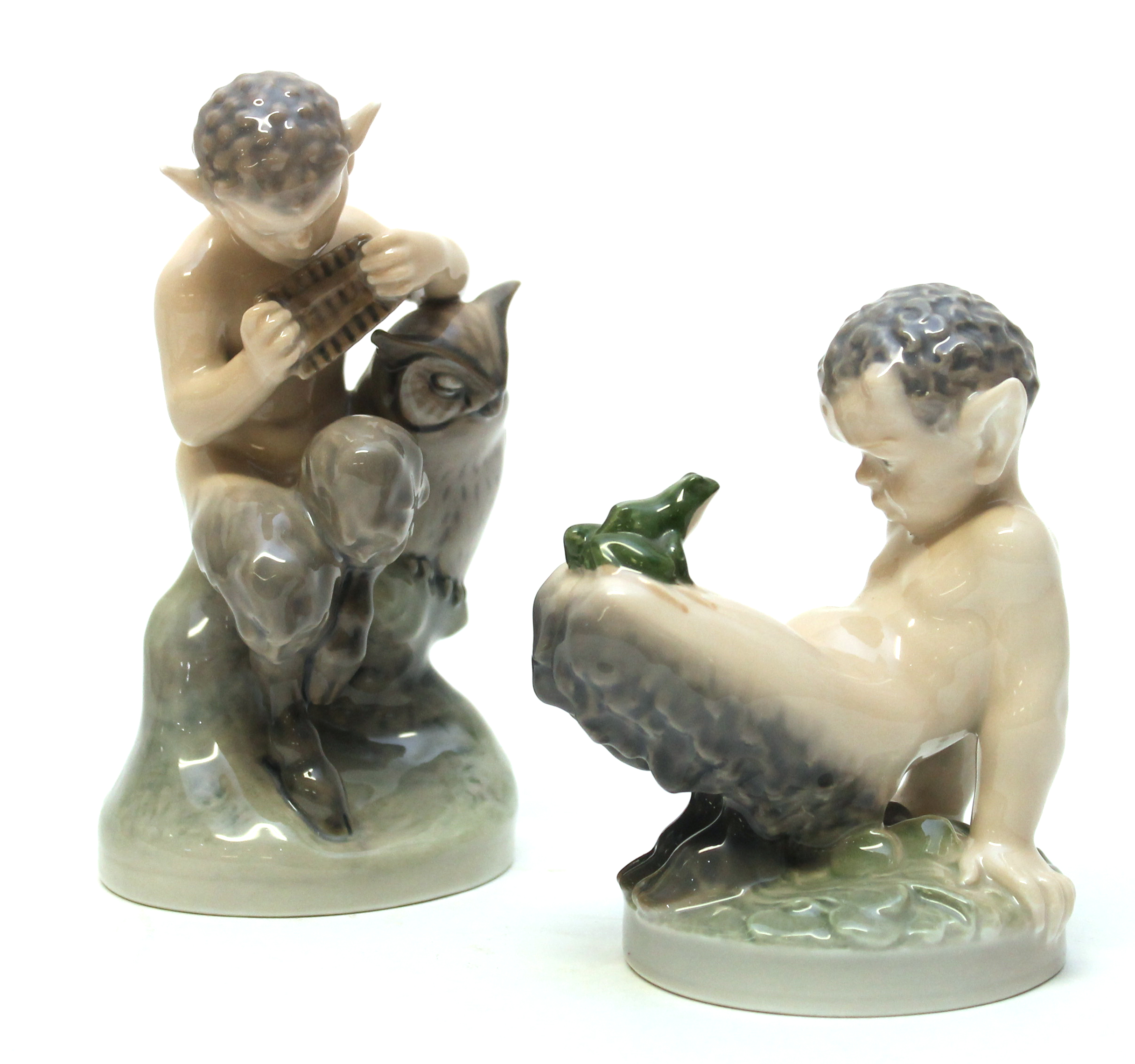 A Royal Copenhagen porcelain model of a young satyr with an owl playing the pipes No 2107 and