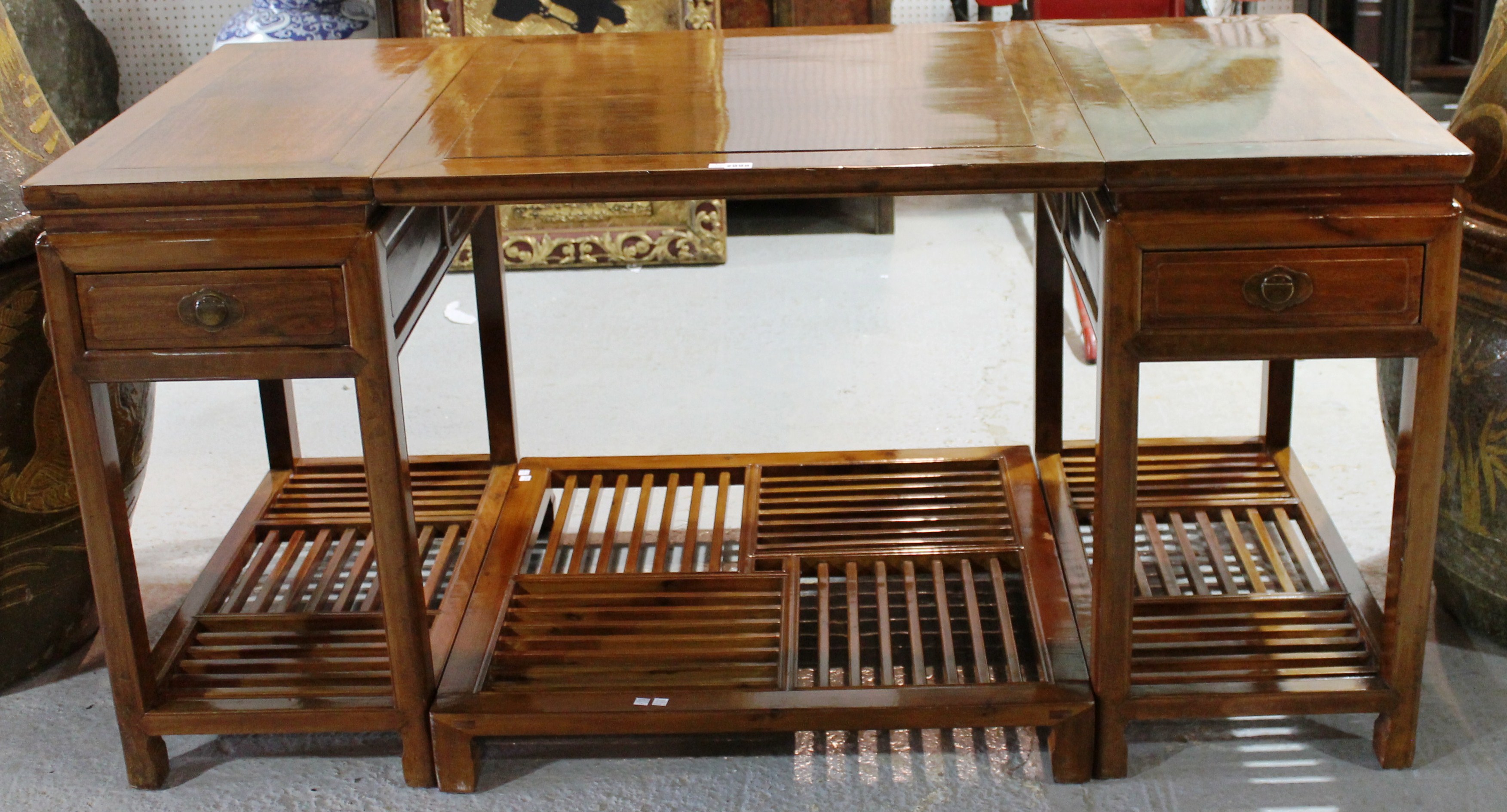 A 20th century Chinese hardwood writing desk, each pedestal with single drawer over a slatted