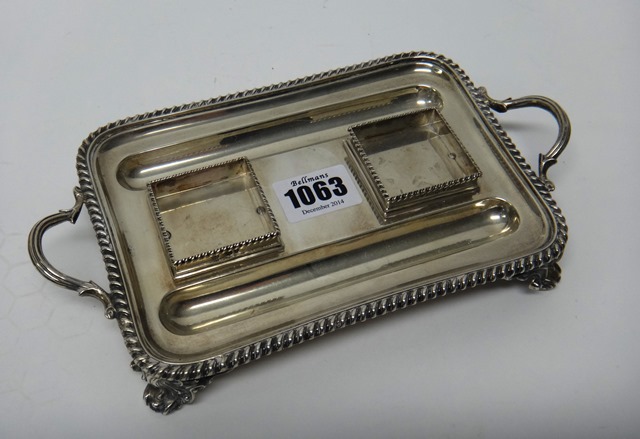 A Victorian silver twin handled rectangular pen and inkstand, decorated with a gadrooned rim and