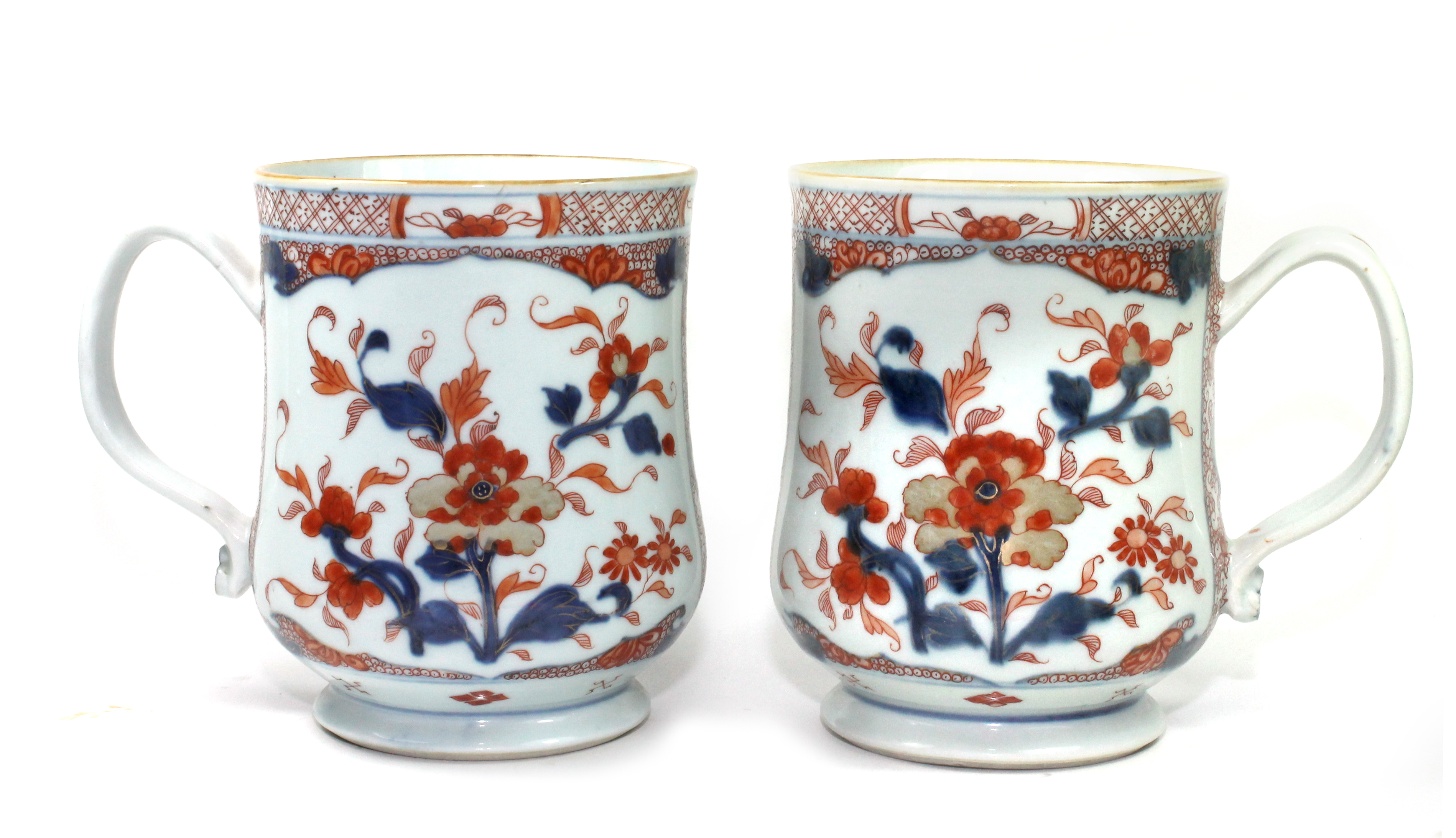 A pair of Chinese Imari baluster tankards, circa 1720-50, painted in underglaze-blue, iron-red and