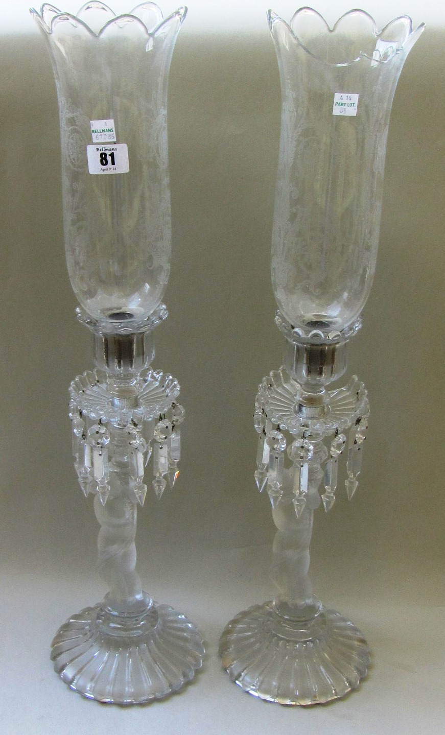 A pair of Baccarat frosted and clear crystal figural candlestick lustres with etched glass storm