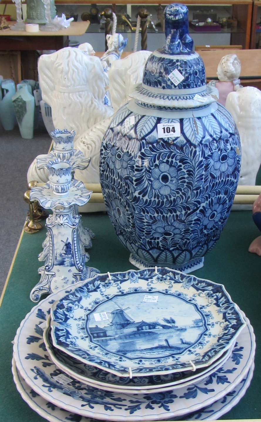 A Dutch Delft blue and white octagonal vase and cover, 18th century, painted with flowers, the cover