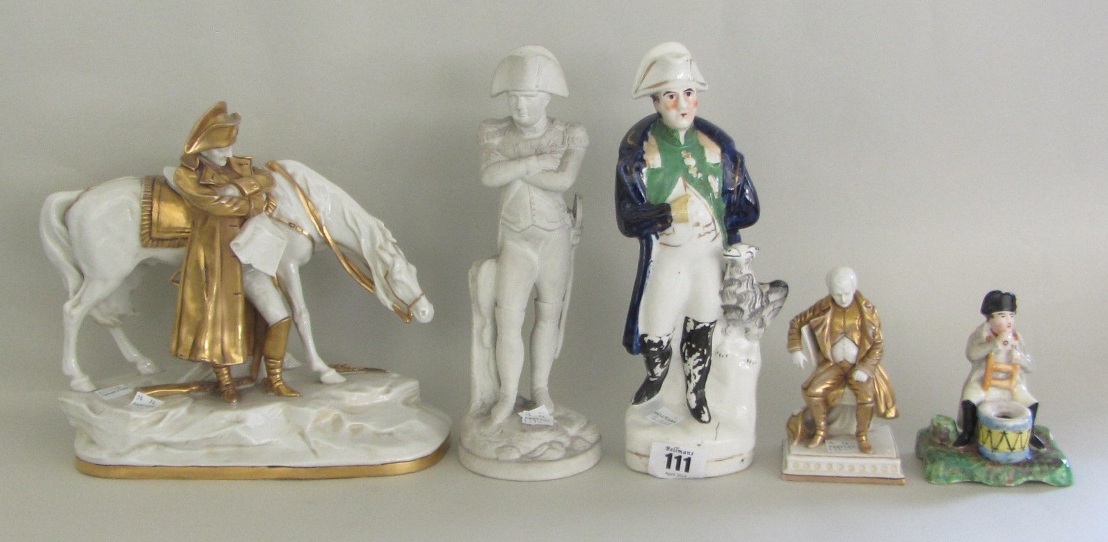 A group of five English and Continental porcelain and pottery figures of Napoleon, 19th and 20th