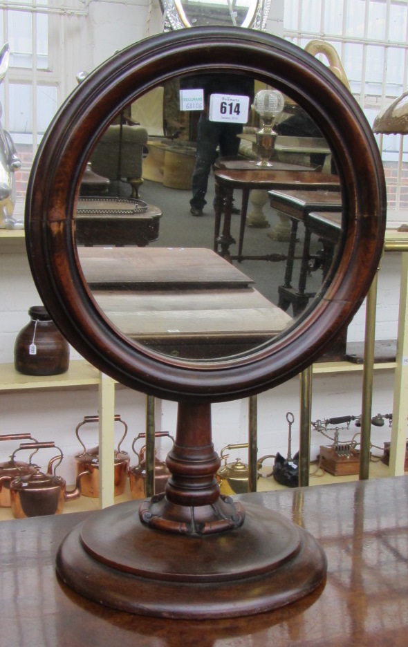 A 19th century circular shaving mirror, on flared circular base, 33cm wide, together with a
