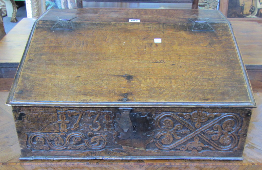 A George II oak slope front writing box, dated 1731, 60cm wide.