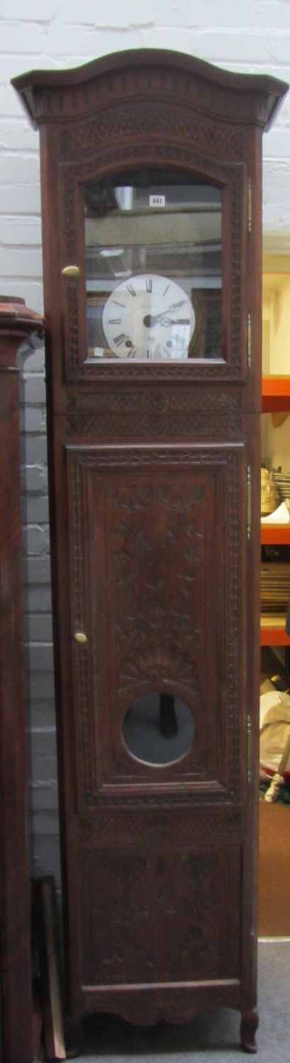 A 19th century French carved oak longcase clock, the circular 8 1/2 inch dial signed 'Poiteuin',