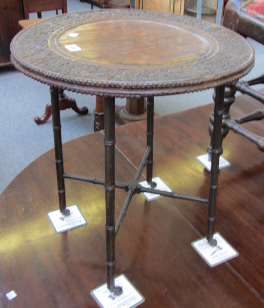 An Anglo Indian rosewood occasional table, the carved circular top on four turned supports with