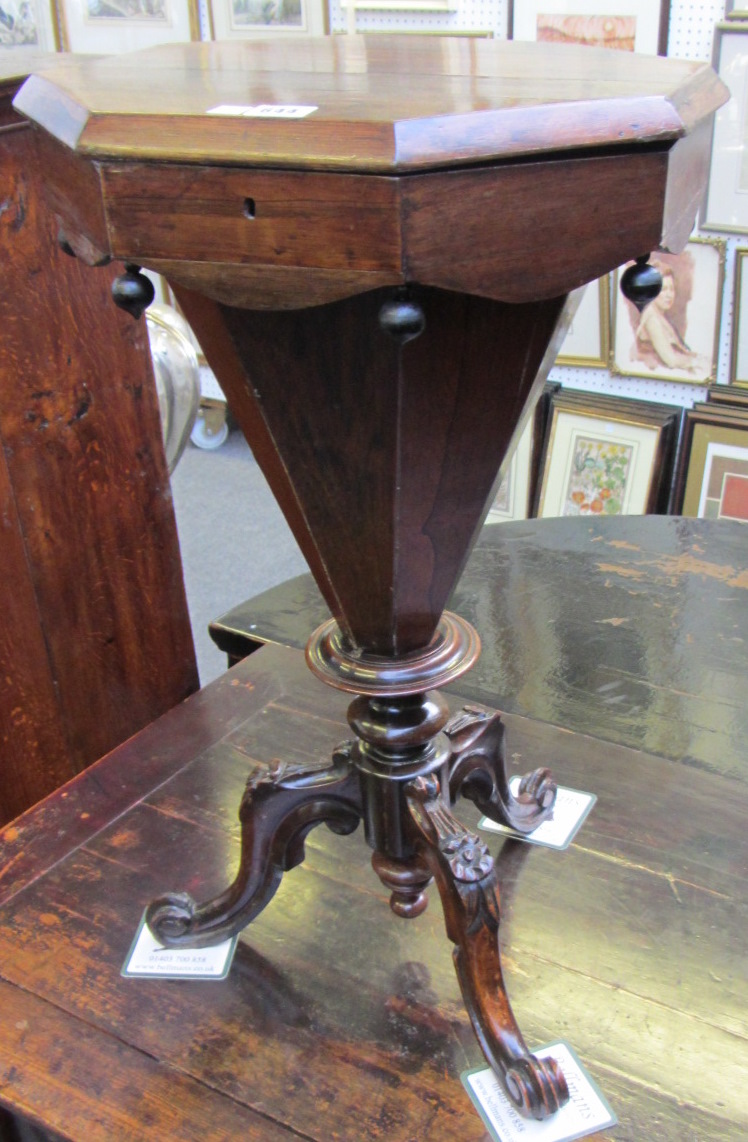 A 19th century rosewood trumpet shape work box, on three downswept supports, 41cm wide.