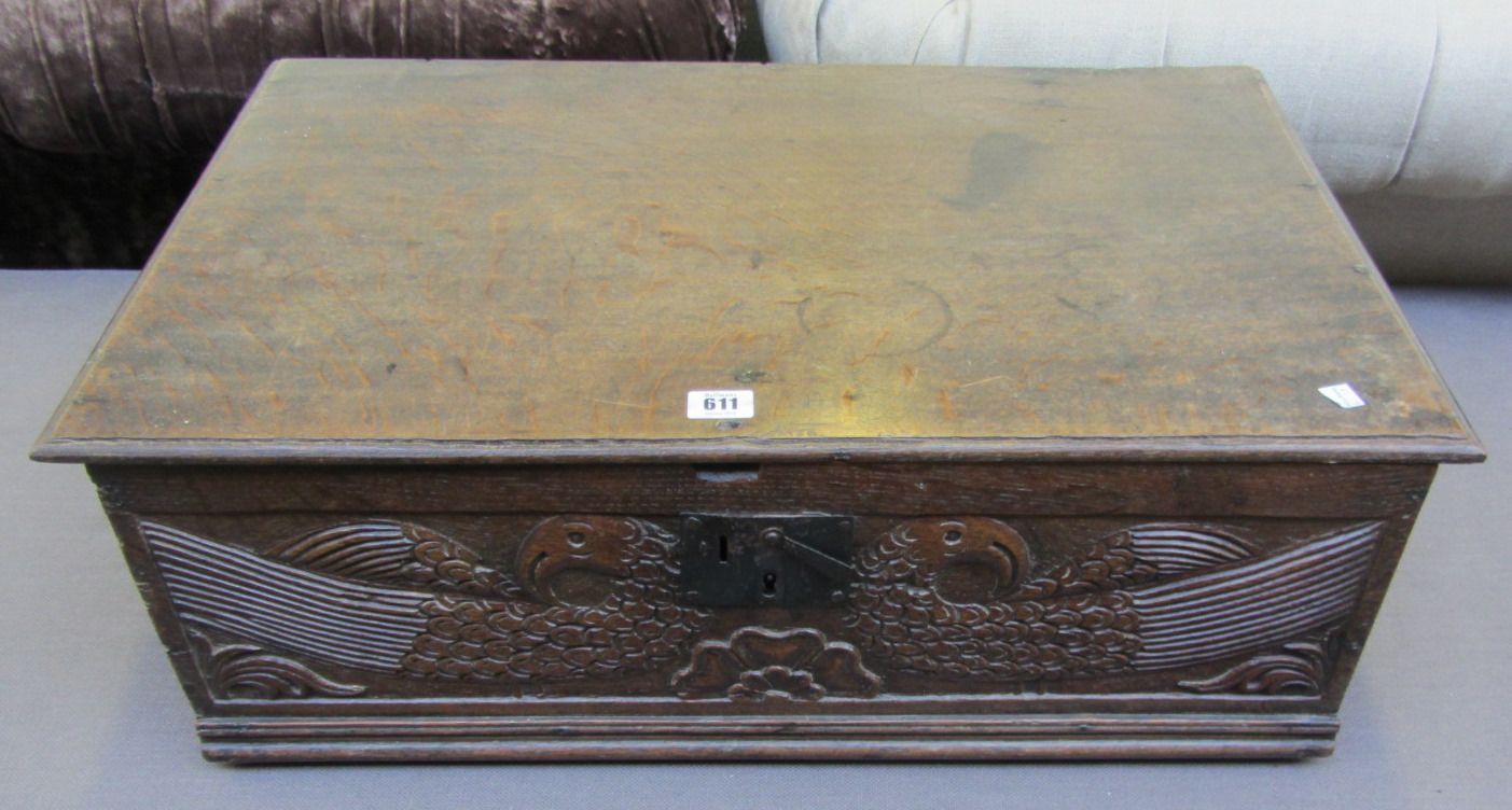 A Charles II rectangular oak box, the front panel carved with a pair of opposing peacocks, 71cm