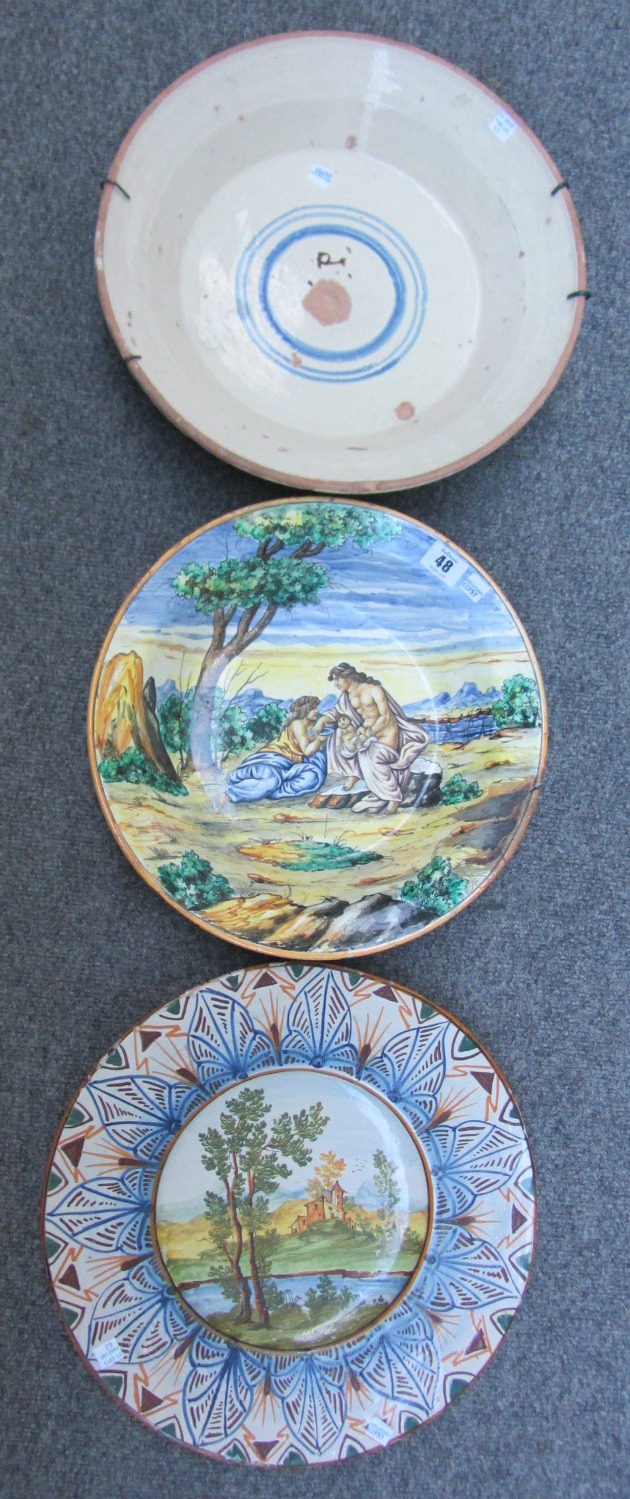 A Castelli maiolica charger, 20th century,  a maiolica  basin painted with figures in a landscape