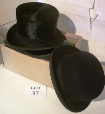 A boxed black top hat and a black bowler hat est: £30-£50 (B120)